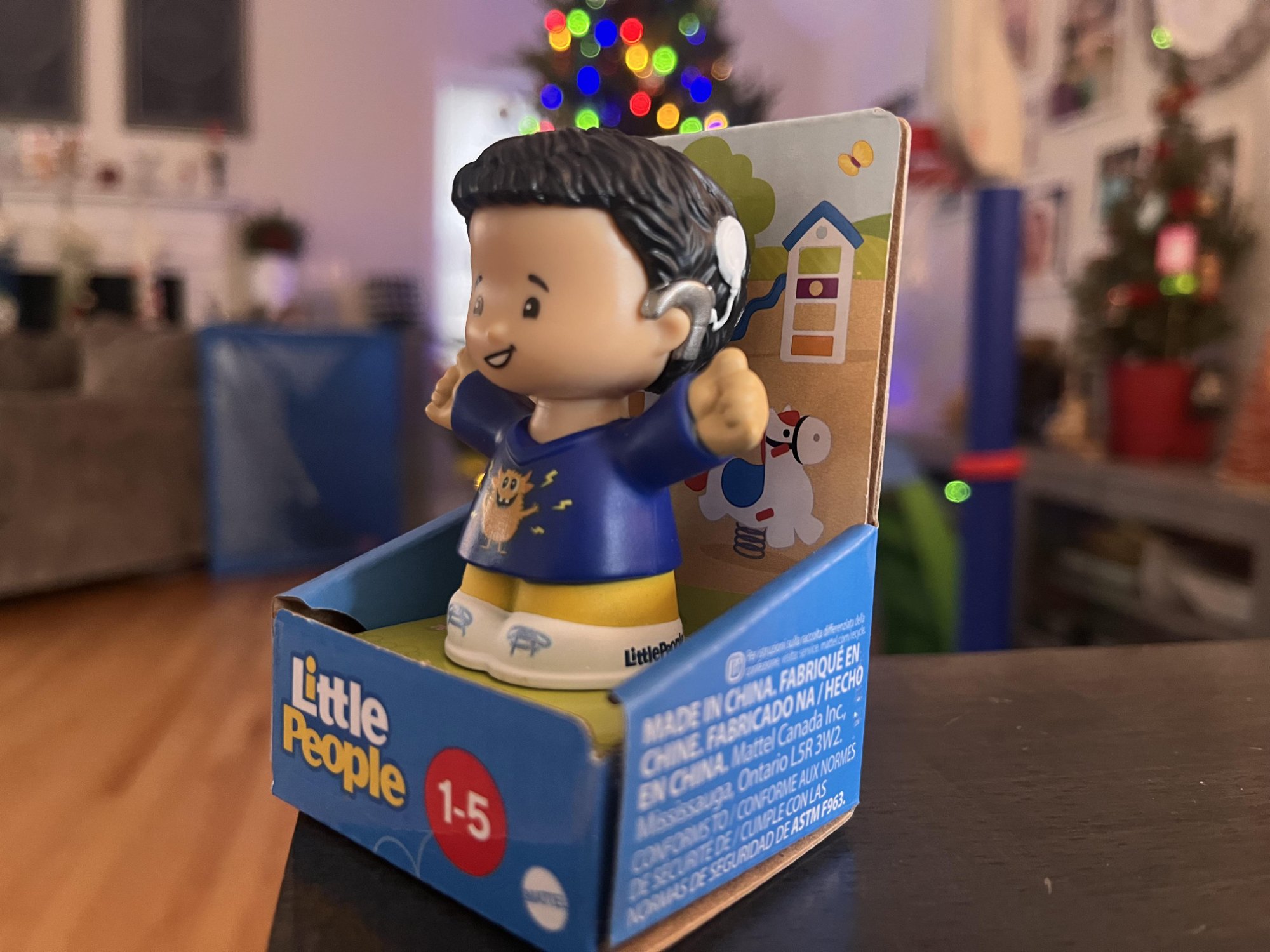 Fisher-Price Little People figure with cochlear implant